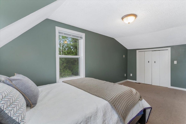 27 Eden St, Goffstown, NH 03102 - bedroom with vaulted ceiling, carpet flooring, baseboards, a textured ceiling, and a closet