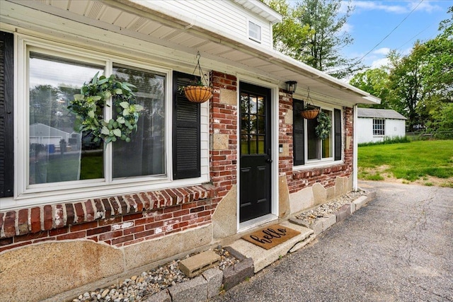 27 Eden St, Goffstown, NH 03102 - doorway to property with brick siding and covered porch