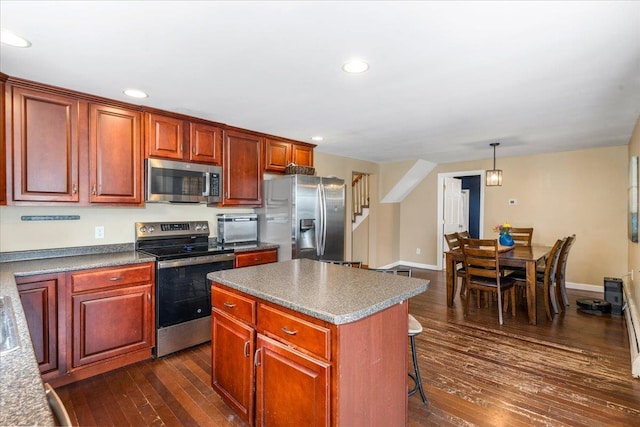 27 Eden St, Goffstown, NH 03102 - kitchen with stainless steel appliances, dark wood finished floors, a kitchen island, a kitchen breakfast bar, and recessed lighting