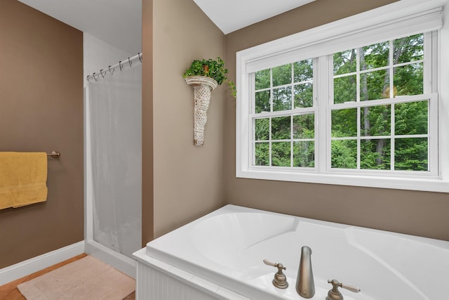 15 Largo Knl, Milford, NH 03055 - full bath with a shower with shower curtain, a garden tub, and baseboards