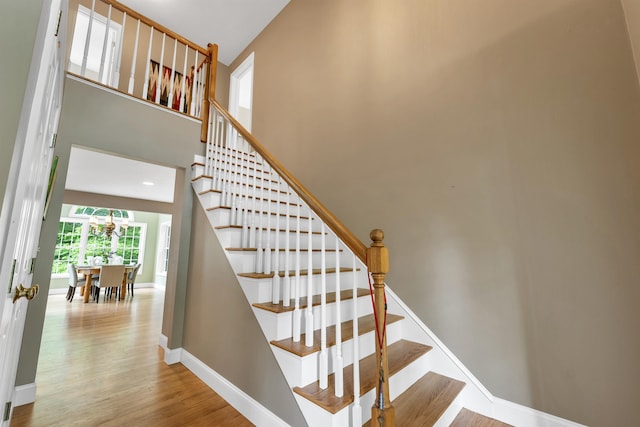 15 Largo Knl, Milford, NH 03055 - stairway featuring wood finished floors, baseboards, and a chandelier