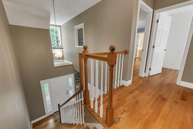 15 Largo Knl, Milford, NH 03055 - hallway with an upstairs landing, wood finished floors, and baseboards