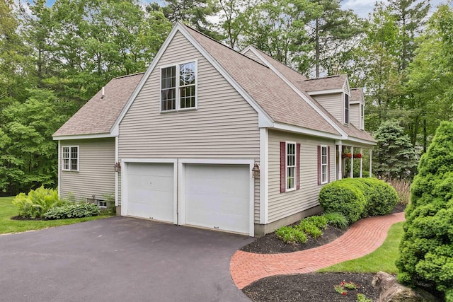 15 Largo Knl, Milford, NH 03055 - view of side of home with roof with shingles, asphalt driveway, and an attached garage