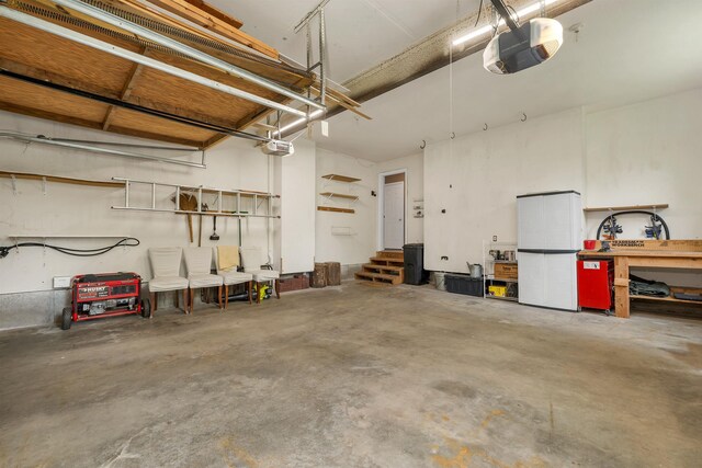 15 Largo Knl, Milford, NH 03055 - garage featuring a garage door opener and a workshop area
