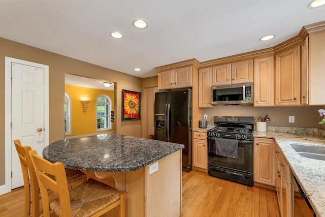15 Largo Knl, Milford, NH 03055 - kitchen featuring black appliances, light wood-type flooring, a breakfast bar, stone countertops, and recessed lighting