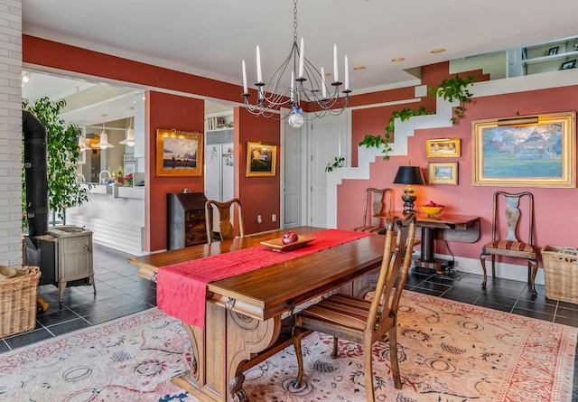 1452 Little Sunapee Rd, New London, NH 03257 - dining area with a wood stove, a chandelier, and dark tile patterned flooring