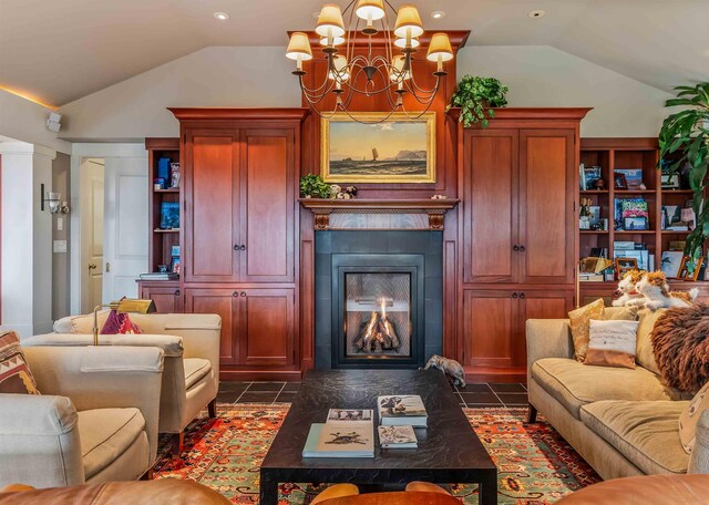 1452 Little Sunapee Rd, New London, NH 03257 - sitting room featuring vaulted ceiling, a chandelier, a lit fireplace, and dark tile patterned floors