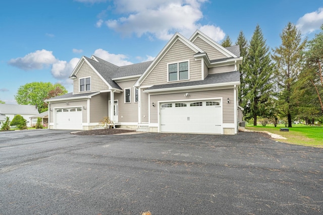 214 Pembroke St Unit A, Pembroke, NH 03275 - view of front of home featuring a garage and roof with shingles