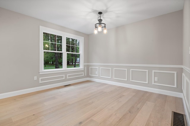 214 Pembroke St Unit A, Pembroke, NH 03275 - unfurnished room featuring light wood finished floors and a chandelier