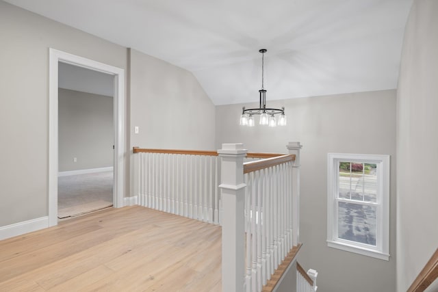 214 Pembroke St Unit A, Pembroke, NH 03275 - stairs featuring a chandelier, lofted ceiling, wood finished floors, and baseboards