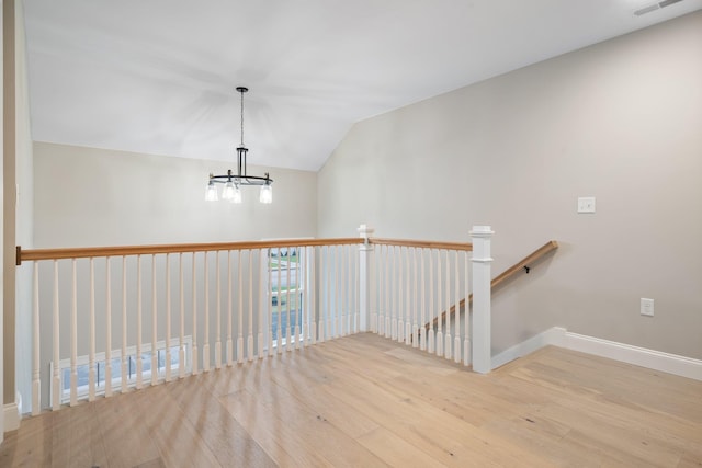 214 Pembroke St Unit A, Pembroke, NH 03275 - staircase with wood finished floors, a chandelier, lofted ceiling, and baseboards