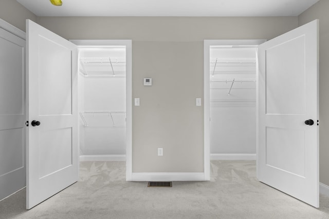 214 Pembroke St Unit A, Pembroke, NH 03275 - unfurnished bedroom with a walk in closet, a closet, and light colored carpet