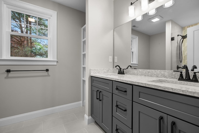 214 Pembroke St Unit A, Pembroke, NH 03275 - full bathroom with double vanity, baseboards, and tile patterned flooring