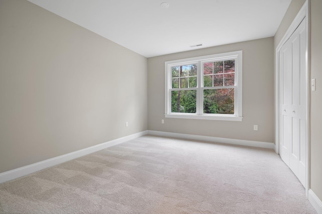 214 Pembroke St Unit A, Pembroke, NH 03275 - unfurnished bedroom with light colored carpet, baseboards, and a closet