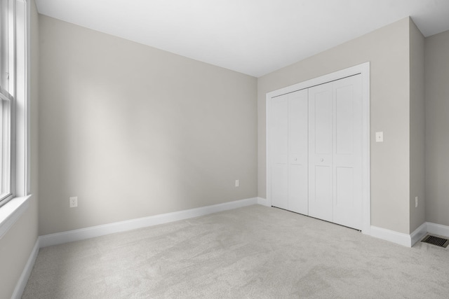214 Pembroke St Unit A, Pembroke, NH 03275 - unfurnished bedroom featuring carpet, a closet, and baseboards