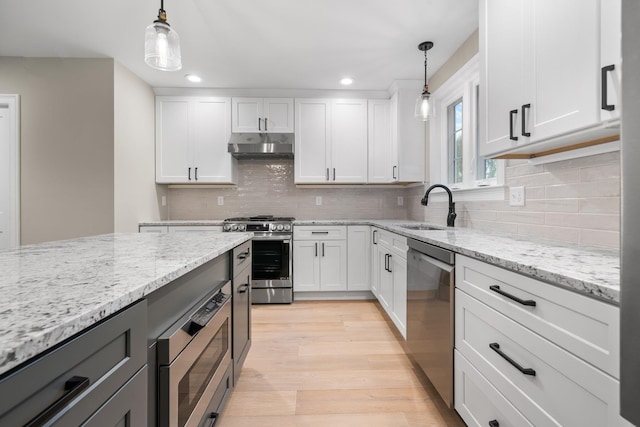 214 Pembroke St Unit A, Pembroke, NH 03275 - kitchen featuring appliances with stainless steel finishes, a sink, under cabinet range hood, recessed lighting, and white cabinetry