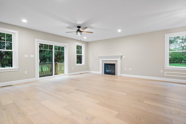 214 Pembroke St Unit A, Pembroke, NH 03275 - unfurnished living room featuring light wood-style flooring, a ceiling fan, baseboards, a glass covered fireplace, and recessed lighting