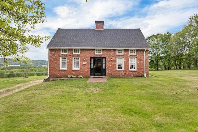 631 Oak Hill Rd, Northfield, NH 03276 - view of front of home with a chimney, a front lawn, brick siding, and roof with shingles