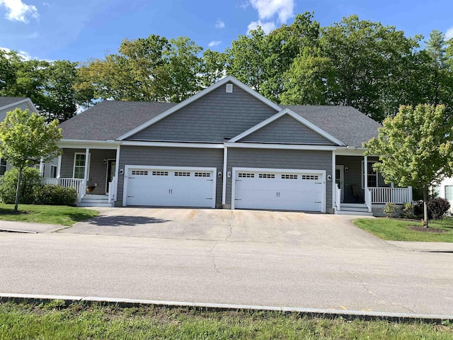 54 Cielo Dr, Dover, NH 03820 - view of front of house featuring covered porch, an attached garage, asphalt driveway, and roof with shingles