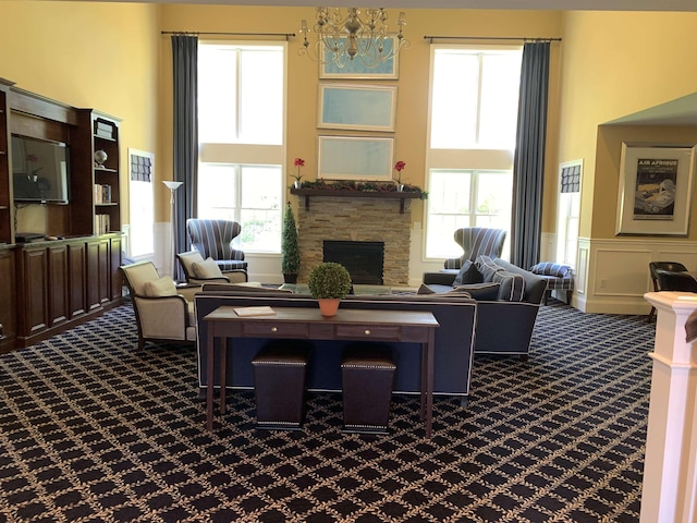 54 Cielo Dr, Dover, NH 03820 - living room with a towering ceiling, dark carpet, healthy amount of natural light, wainscoting, and a decorative wall