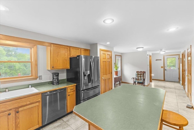 354 Falls Bridge Rd, Williamstown, VT 05679 - kitchen with stainless steel appliances, light tile patterned floors, recessed lighting, and brown cabinetry