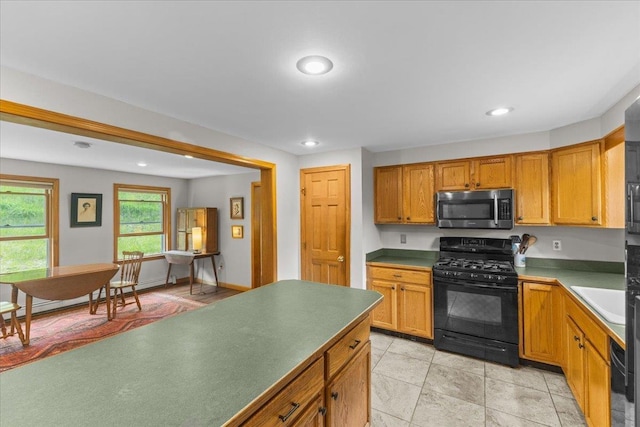 354 Falls Bridge Rd, Williamstown, VT 05679 - kitchen featuring black range with gas stovetop, stainless steel microwave, recessed lighting, dishwashing machine, and brown cabinets