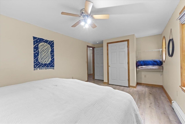 354 Falls Bridge Rd, Williamstown, VT 05679 - bedroom with a baseboard heating unit, wood finished floors, and a ceiling fan