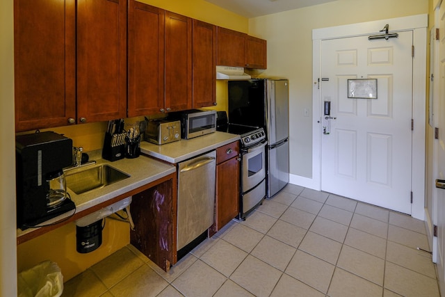 240QII Jackson Gore Inn Unit 240Qii, Ludlow, VT 05149 - kitchen featuring stainless steel appliances, light countertops, light tile patterned floors, baseboards, and under cabinet range hood