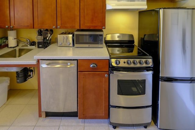 240QII Jackson Gore Inn Unit 240Qii, Ludlow, VT 05149 - kitchen featuring appliances with stainless steel finishes, under cabinet range hood, light countertops, a sink, and light tile patterned flooring