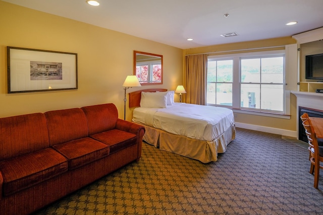 240QII Jackson Gore Inn Unit 240Qii, Ludlow, VT 05149 - bedroom with carpet floors, recessed lighting, baseboards, and a fireplace with flush hearth