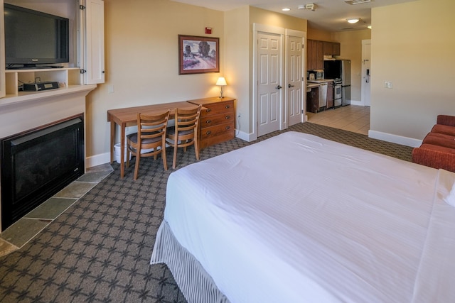 240QII Jackson Gore Inn Unit 240Qii, Ludlow, VT 05149 - bedroom featuring freestanding refrigerator, a fireplace with flush hearth, baseboards, a closet, and carpet
