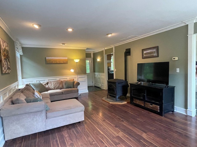 139 Rice Brook Dr, Stoddard, NH 03464 - living room featuring ornamental molding, a wood stove, wood finished floors, wainscoting, and a decorative wall