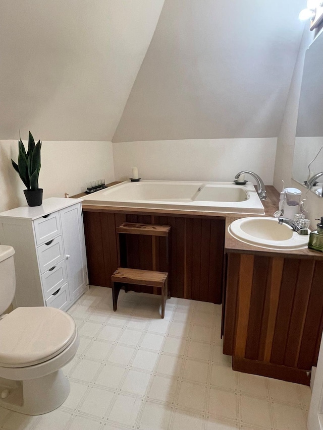 139 Rice Brook Dr, Stoddard, NH 03464 - bathroom featuring lofted ceiling, a bath, tile patterned floors, vanity, and toilet