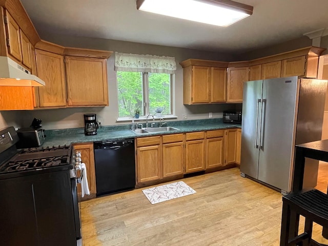 139 Rice Brook Dr, Stoddard, NH 03464 - kitchen with black appliances, under cabinet range hood, a sink, light wood-style floors, and dark countertops