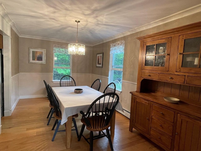 139 Rice Brook Dr, Stoddard, NH 03464 - dining space with healthy amount of natural light, ornamental molding, a chandelier, light wood-style flooring, and a baseboard radiator