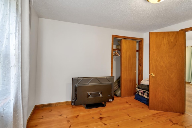 72 Mather Rd, Tamworth, NH 03886 - bedroom featuring hardwood / wood-style flooring, a closet, and a textured ceiling