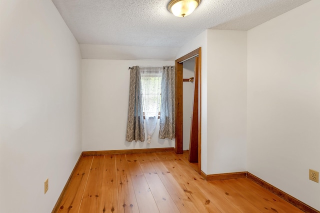 72 Mather Rd, Tamworth, NH 03886 - spare room featuring light wood finished floors, a textured ceiling, and baseboards