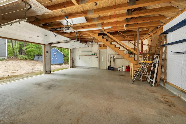 72 Mather Rd, Tamworth, NH 03886 - garage featuring a shed and a garage door opener