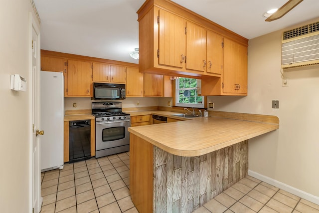 1 Pepperell Cir, Nashua, NH 03062 - kitchen featuring appliances with stainless steel finishes, light tile patterned floors, a peninsula, light countertops, and baseboards