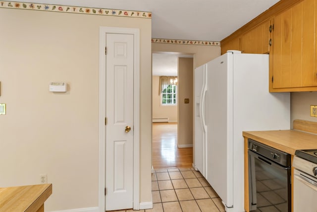 1 Pepperell Cir, Nashua, NH 03062 - kitchen with a baseboard heating unit, light tile patterned floors, white refrigerator with ice dispenser, range, and baseboards