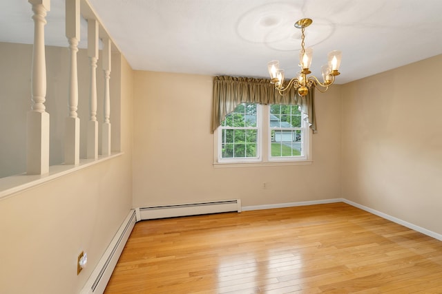 1 Pepperell Cir, Nashua, NH 03062 - unfurnished room featuring a baseboard heating unit, light wood-type flooring, a chandelier, and baseboards