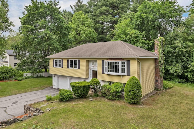 1 Pepperell Cir, Nashua, NH 03062 - split foyer home featuring a chimney, a front yard, an attached garage, driveway, and a shingled roof