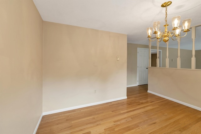 1 Pepperell Cir, Nashua, NH 03062 - empty room with a chandelier, baseboards, and wood finished floors