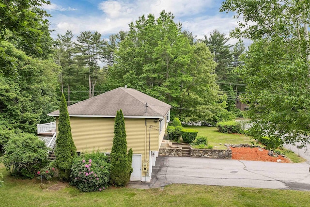 1 Pepperell Cir, Nashua, NH 03062 - view of home's exterior with roof with shingles, a patio area, a lawn, and driveway