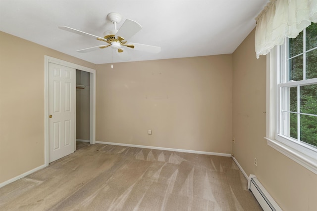 1 Pepperell Cir, Nashua, NH 03062 - unfurnished bedroom featuring baseboard heating, light colored carpet, baseboards, and a closet