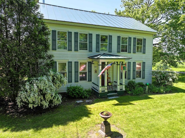 358 S Main St, Whiting, VT 05778 - colonial house featuring a standing seam roof, metal roof, and a front lawn