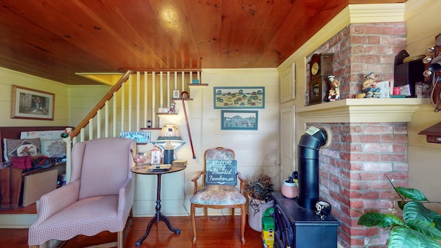 358 S Main St, Whiting, VT 05778 - living area with wooden ceiling, stairs, wood finished floors, crown molding, and a wood stove