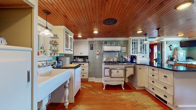 358 S Main St, Whiting, VT 05778 - kitchen featuring wood ceiling, dark countertops, wood finished floors, open shelves, and a peninsula