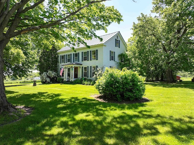 358 S Main St, Whiting, VT 05778 - view of front facade with a standing seam roof, a front lawn, and metal roof