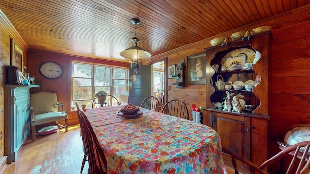 358 S Main St, Whiting, VT 05778 - dining area with wood walls, wooden ceiling, light wood-style floors, and crown molding